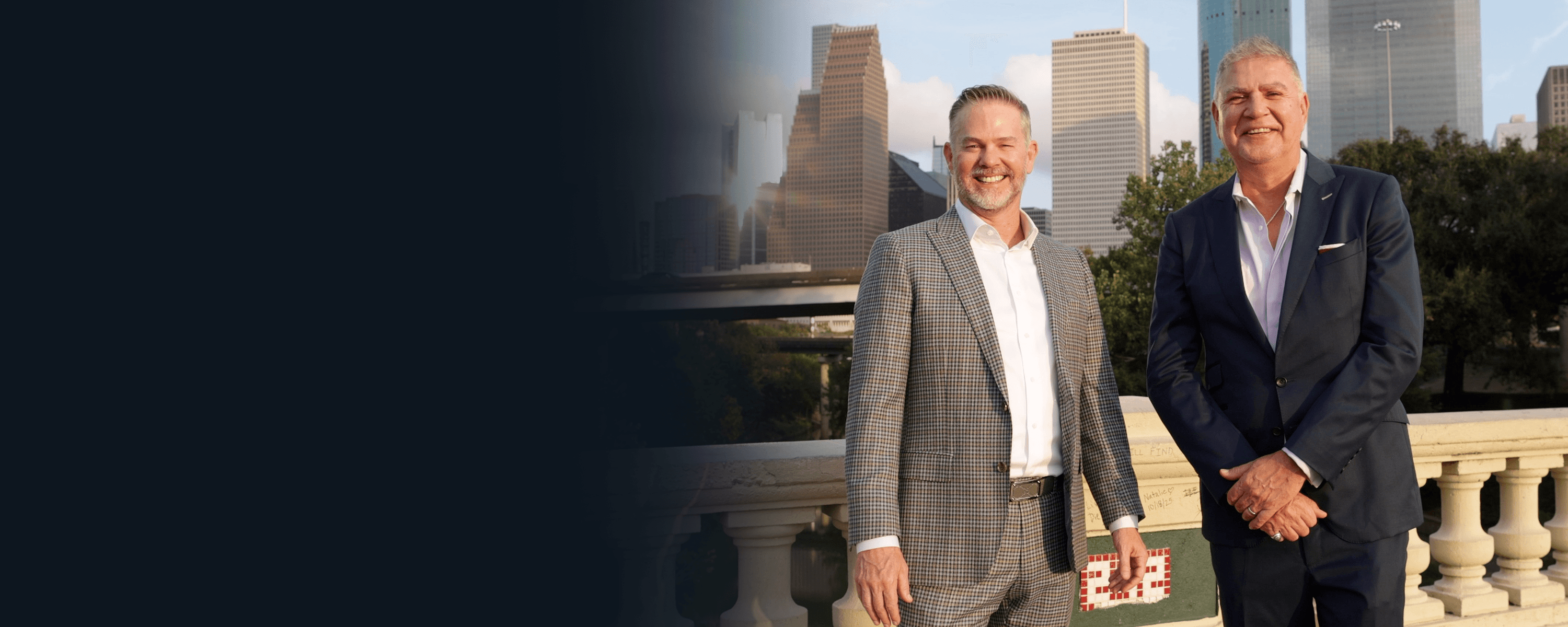 Two attorneys standing together with a city skyline in the background.